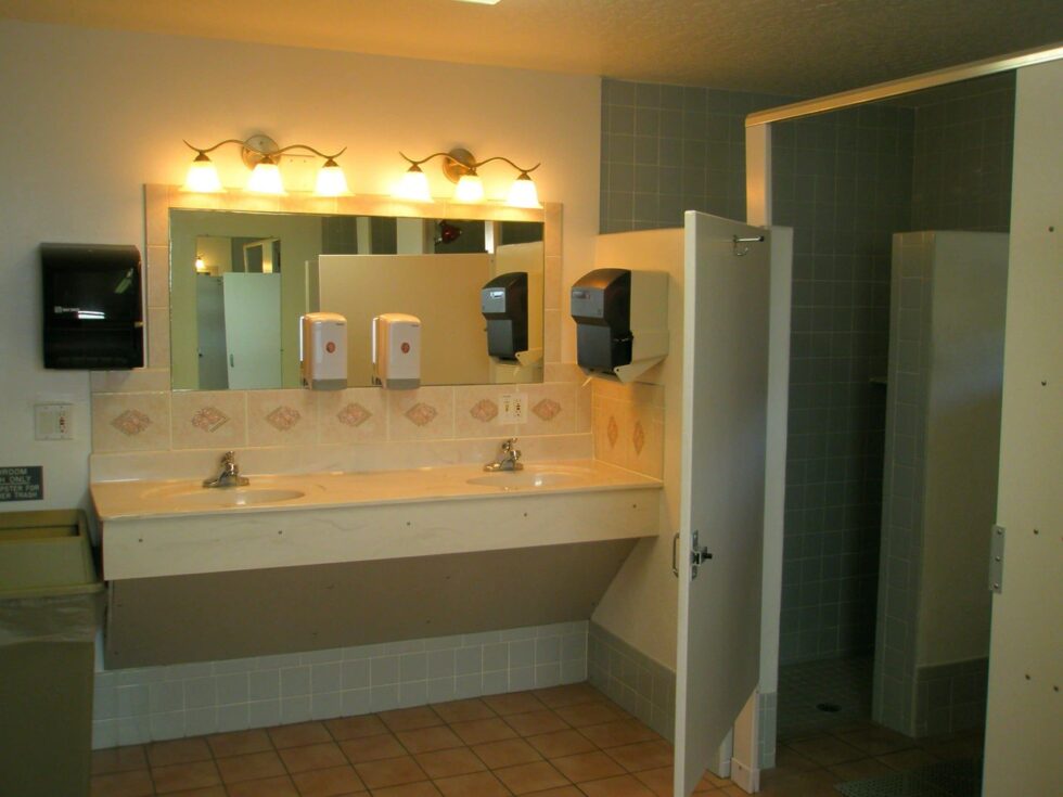 Clean and well-maintained restrooms with tiled showers at Camelot RV Park in Malabar, Florida